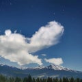 Large mountains with forest clearings into which clouds crash