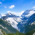 Large mountains with forest clearings into which clouds crash Royalty Free Stock Photo