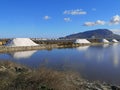 Large mountains of salt at the salt pans in Paceco, Sicily, Italy. Salt extraction. Royalty Free Stock Photo