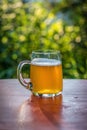 Large mug of beer on table outside