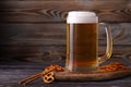 A large mug of cold, fresh, tasty, lager beer with foam and a snack of salted pretzels Royalty Free Stock Photo