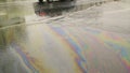 A large multi-colored gasoline stain
