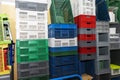 Large multi-colored plastic boxes for goods and products stand as a wall in a warehouse Royalty Free Stock Photo