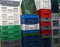 Large multi-colored plastic boxes for goods and products stand as a wall in a warehouse Royalty Free Stock Photo