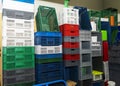 Large multi-colored plastic boxes for goods and products stand as a wall in a warehouse Royalty Free Stock Photo