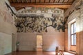 Large museum room decorated with ruins of ancient frescoes