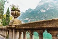 Large natural stone vases decorate the balustrade of a lakeside promenade Royalty Free Stock Photo