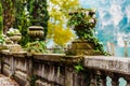 Large natural stone vases decorate the balustrade of a lakeside promenade Royalty Free Stock Photo