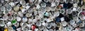 A large number of caps from cans of aerosol paint for graffiti. Smeared with colored paint nozzles lie in a huge pil Royalty Free Stock Photo