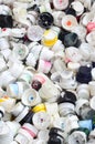 A large number of caps from cans of aerosol paint for graffiti. Smeared with colored paint nozzles lie in a huge pil Royalty Free Stock Photo