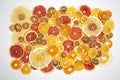 Large number of dried pieces of citrus fruit on white background