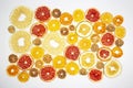 Large number of dried pieces of citrus fruit on white background