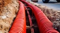 Large number of electric and high-speed Internet Network cables in red corrugated pipe on the street covered with
