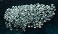 A large number of heaps of beautiful expensive cut diamonds on a black background