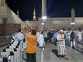 Pilgrims gather at night in the outer courtyard of Masjid Al Nabawi, Madinah.