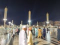 Pilgrims gather at night in the outer courtyard of Masjid Al Nabawi, Madinah.