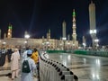 Pilgrims gather at night in the outer courtyard of Masjid Al Nabawi, Madinah.