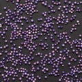 A large number of purple balls on a black background