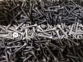 A large number of silver chrome-plated identical screws Royalty Free Stock Photo