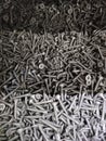A large number of silver chrome-plated identical screws . Royalty Free Stock Photo