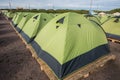 A large number of tents on a sandy beach, lined up strictly in a Royalty Free Stock Photo