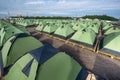 A large number of tents on a sandy beach, lined up strictly in a Royalty Free Stock Photo