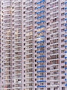 A large number of windows and balconies on building facade. Apartment block. Residential building. Royalty Free Stock Photo