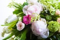 A large number of yety, a large lush bouquet of snowdrop, rose, bell and peony with greens in a large long stylish