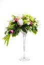 A large number of yety, a large lush bouquet of snowdrop, rose, bell and peony with greens in a large long stylish