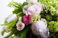 A large number of yety, a large lush bouquet of snowdrop, rose, bell and peony with greens in a large long stylish