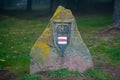 A large obelisk is placed next to the tourist trail with a trail sign and an eagle on it Royalty Free Stock Photo