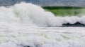 Large Ocean Wave breaking over its funnel