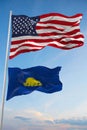 Large official Flag of US with smaller flag of Oregon state, Usa at cloudy sky background. United states of America patriotic