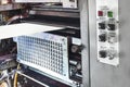 A large offset printing press running a long roll off paper over its rollers