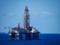 Large offshore oil rig in the middle of a vast expanse of ocean