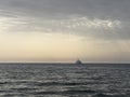 large offshore tourist ship in the sea at sunset