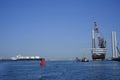 A large offshore vessel with a crane and a helipad is moored in the seaport of Rotterdam. A Jack-up vessel for use in the offshore