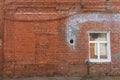 Large old dilapidated red brick house with a white window. Old dirty abandoned factory building Royalty Free Stock Photo