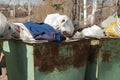 Large, old, rusty metal trash cans.