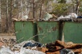 Large, old, rusty metal trash cans.