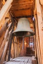 A big old bell hanging in a wooden church`s old tower Royalty Free Stock Photo