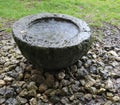 Large old stoup carved into the rock with water