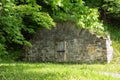 Large old 19th Century stone root cellar with arched top seen