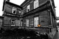 Large old wooden house in black and white with yellow tabby cat. Royalty Free Stock Photo