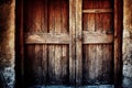 Large old wooden medieval door with crossbars in stone wall.