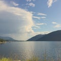 Large ominous thunder cloud at lake