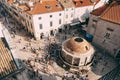 Main street Stradun full of tourists near church of St. Saviour and Big Onofrio fountain in city of Dubrovnik Royalty Free Stock Photo