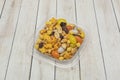 A large, opalescent plastic bowl brimming with a mix of n alnuts, hazelnuts, and pistachios, perfect for snacking Royalty Free Stock Photo