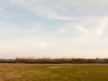 large open farm field empty grass grassland spring sky