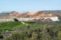 a large open pit on a hillside covered in trees and dirt Royalty Free Stock Photo